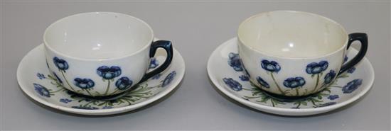 2 Macintyre Burslem Blue Poppy pattern white ground cups/saucers, early 20th C saucer 14cm, one cup & saucer restored(-)